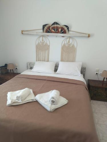 a bed with two towels on top of it at Kampus Living Luxury Complex in Faliraki