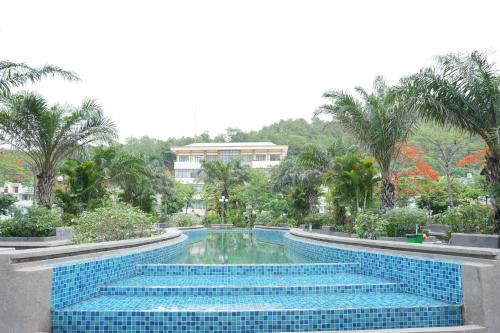a swimming pool with blue tiles in a resort at Boom'homes- Căn hộ view Vịnh Hạ Long in Ha Long