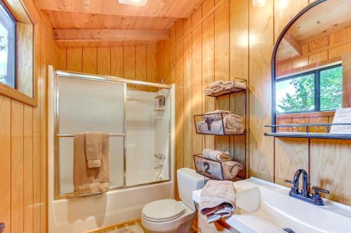a bathroom with a shower and a toilet and a sink at Lakefront Innsbrook Chalet Hot Tub and Fire Pit! in Wright City
