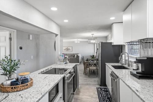 a kitchen with white counter tops and a dining room at Tucson Oasis by Rather Be Properties in Tucson