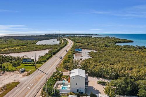an aerial view of a road and a house next to a highway at Blue Breeze in Duck Key