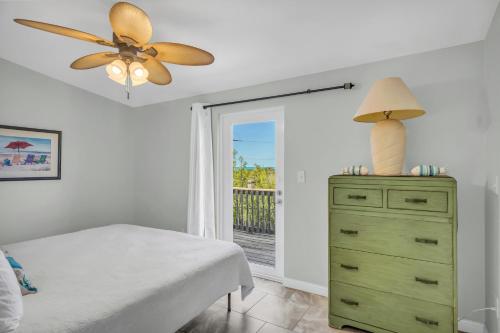 a bedroom with a bed and a ceiling fan at Blue Breeze in Duck Key