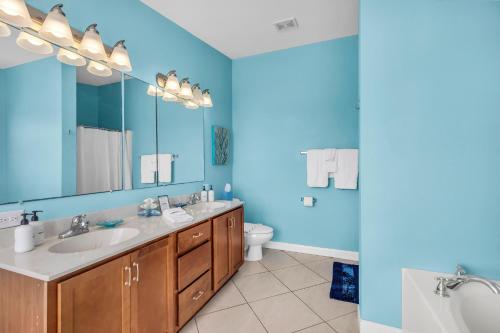 a bathroom with a sink and a toilet and a mirror at Blue Breeze in Duck Key