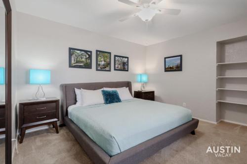 a bedroom with a bed and two night stands with blue lamps at 2 Miles to DT Updated Pet-Friendly Home for Four in Austin