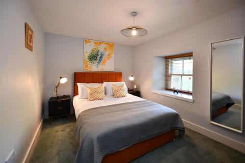 a bedroom with a bed and a window in it at 20 The Courtyard, Ballochmyle House in Mauchline