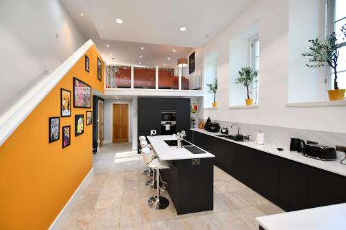 a kitchen with a yellow and white wall at 20 The Courtyard, Ballochmyle House in Mauchline