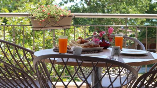 a table with food and two glasses of orange juice at Evilion in Asprovalta