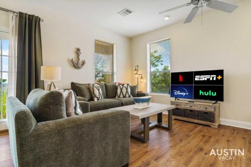 a living room with a couch and a tv at Lakeway Hideaway Cool Spot by The Colorado River in Austin