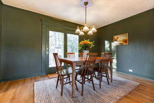 a dining room with a wooden table and chairs at The Green House - Central location PTC - Trilith in Tyrone