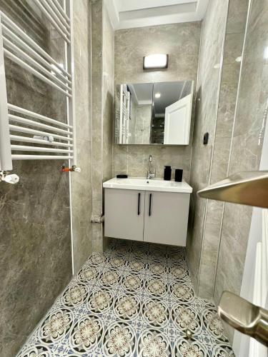 a bathroom with a sink and a mirror at Anfora Villaları in Belek