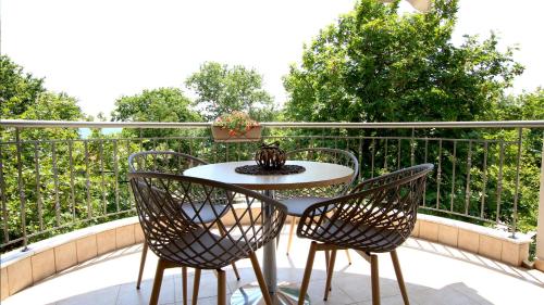 a table and two chairs on a balcony at Evilion in Asprovalta