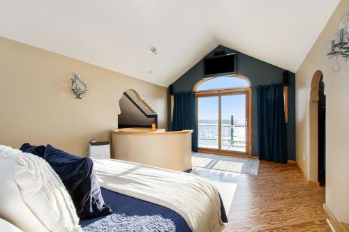a bedroom with a bed and a large window at Lake Michigan Retreat- Upper Duplex in Benton Harbor