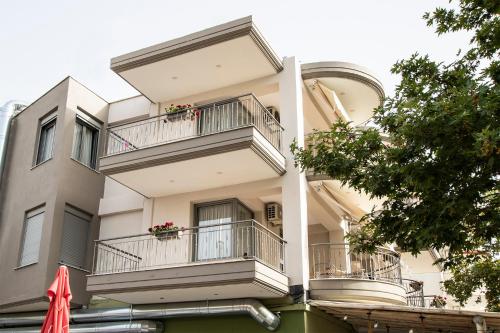 a building with balconies and flowers on it at Evilion in Asprovalta