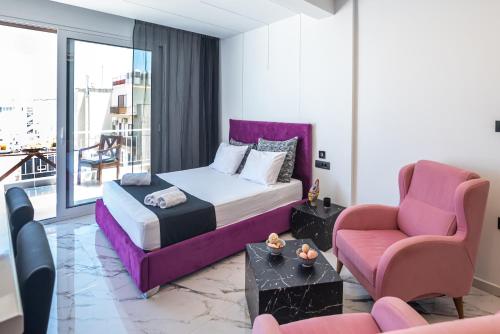 a bedroom with a bed and a couch and a chair at Vip penthouse patra in Patra