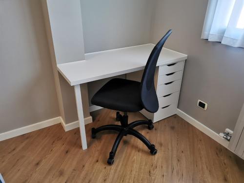 a white desk with a black chair in a room at Lake&Stars - Il lago e le stelle in Ispra