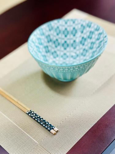 a blue bowl and a chopstick on a table at villa by mount in Ratmalana
