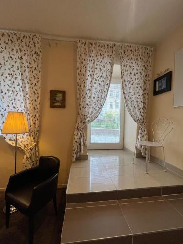 a living room with a window and a chair at St Martin Apartment in Vienna