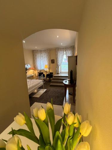 a living room with yellow flowers in a vase at St Martin Apartment in Vienna