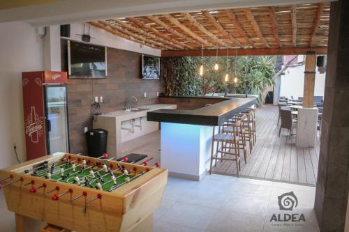 a kitchen with a foosball table in the middle at ALDEA Luxury villas & suites in San Martín de las Pirámides