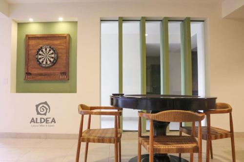 a dart board on a wall next to two chairs at ALDEA Luxury villas & suites in San Martín de las Pirámides