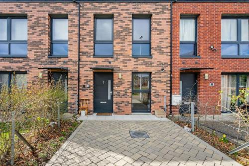 a brick building with a front door and windows at Bright, modern 2 bedroom house with free parking! in Edinburgh