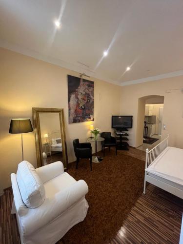 a living room with a white couch and a bed at St Martin Apartment in Vienna