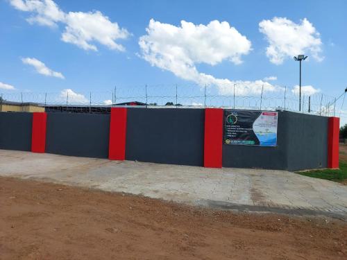a blue and red fence with a sign on it at The Irenic Massage Spa and bnb in Hebron