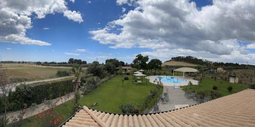 a view of a resort with a swimming pool and a yard at Agriturismo Fieri in Botricello