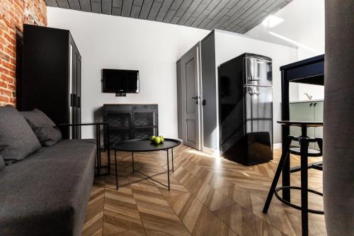a living room with a couch and a table at Old brick boutique apartments in Klaipėda