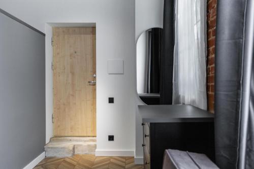 a kitchen with a sink and a door at Old brick boutique apartments in Klaipėda