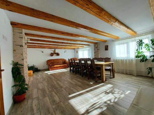 a living room with a table and chairs and a couch at Casa Adi in Moieciu de Sus