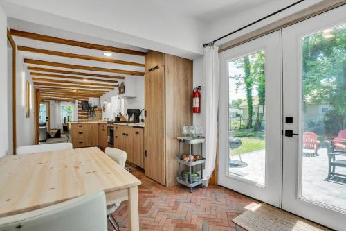 a kitchen and dining room with a wooden table at Modern Log Cabin at the beach with Hot Tub, Game Room and Fire Pit in Del Haven