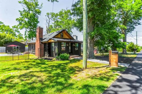 a house with a pole in the grass at Modern Log Cabin at the beach with Hot Tub, Game Room and Fire Pit in Del Haven