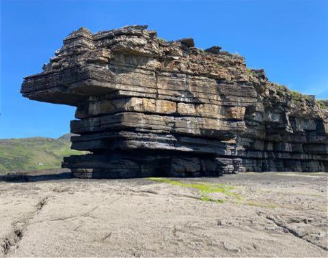 a large rock structure sitting on top of a hill at Memory Lane Self Catering Cottage in Muckros