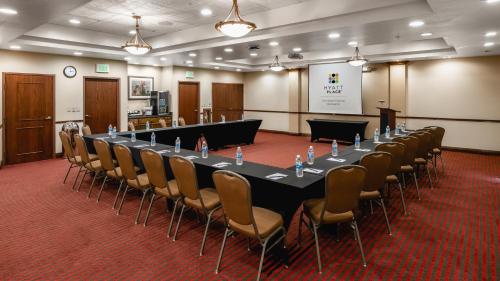 a conference room with a long table and chairs at Hyatt Place Fort Worth Stockyard in Fort Worth