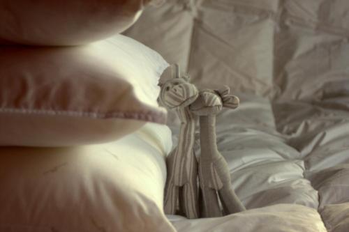 a close up of a bed with a bunch of pillows at Home BB Milano in Milan