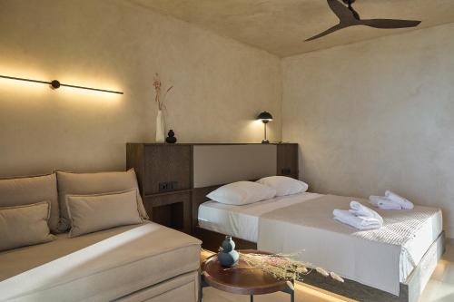 a room with two beds and a couch at Casa Tsouka ApartHotel in Fanárion