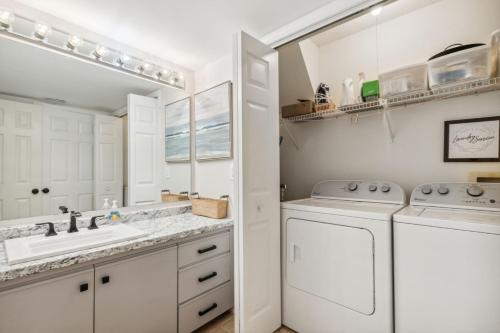 a white laundry room with a washer and dryer at 2625 Forest Ridge - Pool - Tennis - Pickleball - Large Deck in Fernandina Beach
