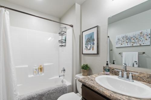 a white bathroom with a sink and a toilet at Destiny Cove in Kalispell