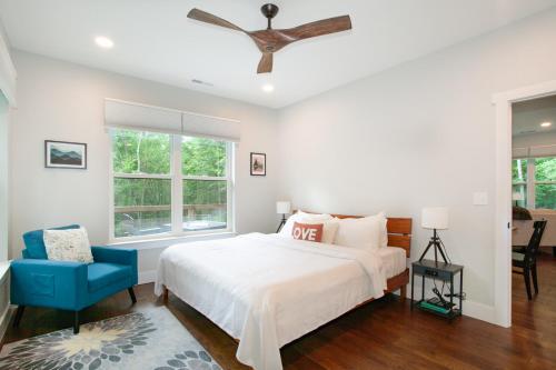 a bedroom with a bed and a blue chair at Townsend Gem: Retreat with Hot Tub & Fire Pit in Townsend