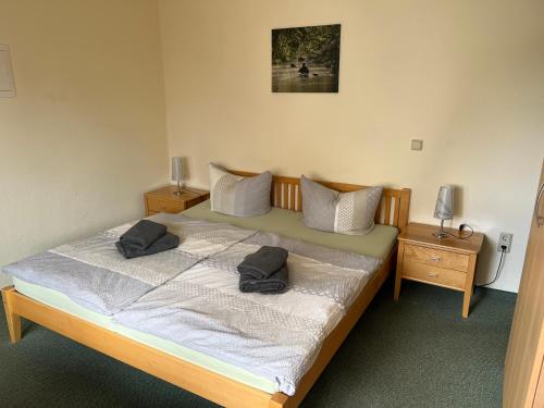 a bedroom with a bed with two pillows on it at Pension Spreewaldstube in Vetschau
