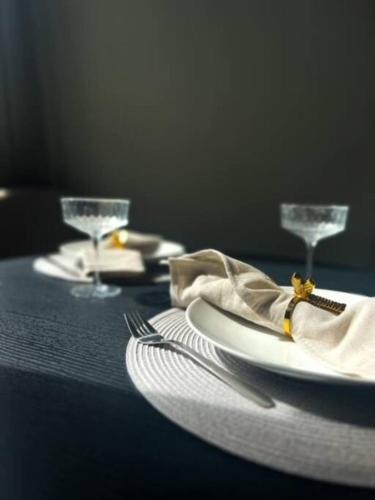 a table with plates and wine glasses on it at 3P comfortable apt next to Fontys in citycenter in Tilburg