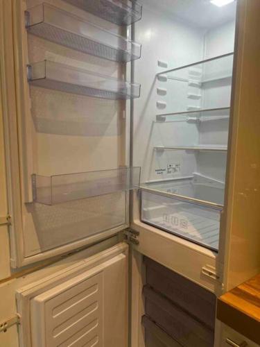 an empty refrigerator with its door open in a kitchen at 3P comfortable apt next to Fontys in citycenter in Tilburg