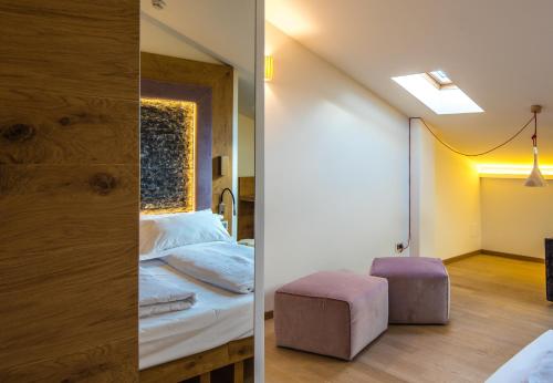 two images of a bedroom with a bed and a stool at Albergo Caffe Centrale in Mezzocorona