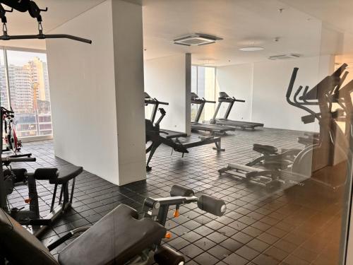 une salle de sport avec plusieurs tapis de course et vélos d'exercice dans l'établissement Loft vista mar terraza jacuzzi, à Santa Marta