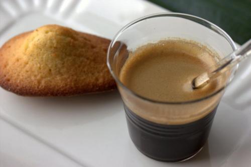 a glass of coffee next to a piece of bread at Home BB Milano in Milan