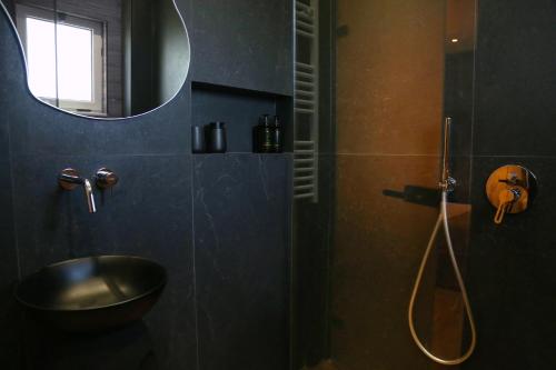a bathroom with a sink and a shower with a mirror at Foga Hebrus in Ksamil