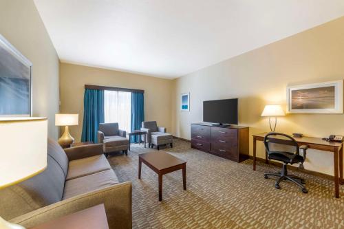 a living room with a couch and a desk at Best Western Naples Plaza Hotel in Naples