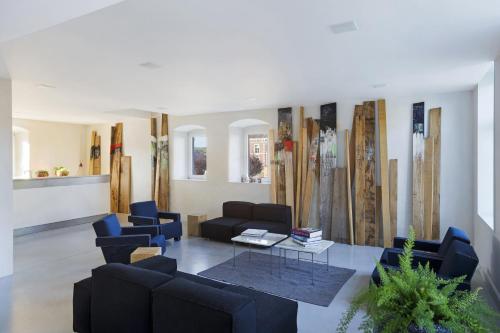a living room with couches and a table and chairs at B&B Opus35 in Montzen