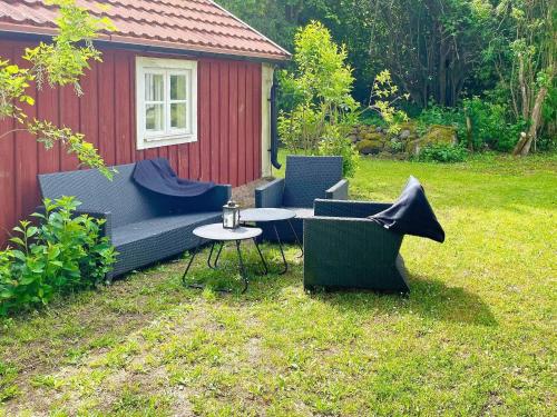 a garden with a couch and chairs and a table at 4 person holiday home in FÄRJESTADEN-By Traum in Färjestaden
